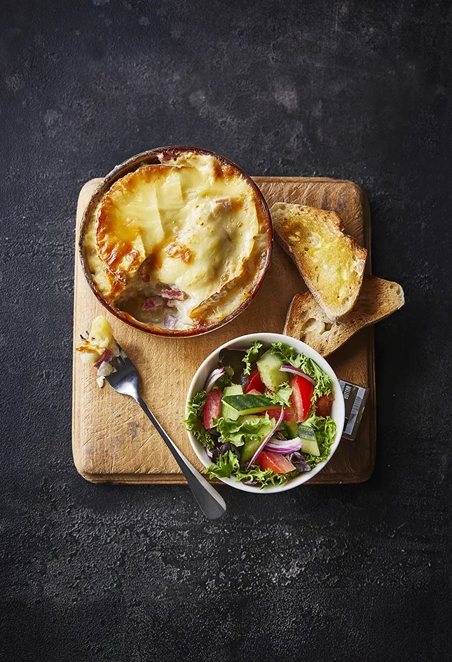 Tartiflette on slate background